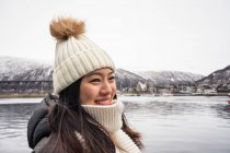 Asian female in warm wear at snowy mountain area — Stock Photo