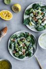 From above appetizing healthy salmon salad with greenery and cut lemon lime on served table — Stock Photo