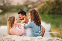 Happy casual multiracial parents together with daughter in nature — Stock Photo