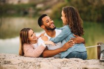 Happy casual multiracial parents together with daughter in nature — Stock Photo