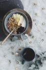 Vue du dessus de la mise en page repas bio sain avec baies et pommes et lait et muesli dans un bol sur la plaque de cuisson près avec une tasse de thé — Photo de stock