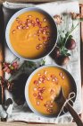Served bowls of delicious pumpkin soup — Stock Photo