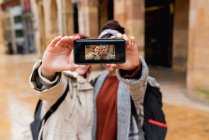 Le donne multietniche liete equilibrate che prendono selfie a telefonino e mostrano la fotografia a macchina fotografica in strada — Foto stock