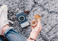 Woman with photo camera and compass — Stock Photo