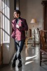 Serious confident elegant man looking out window in country house — Stock Photo