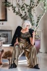 Serious bossy elderly woman in luxurious outfit against vintage interior bathroom — Stock Photo