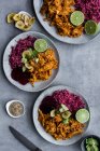 Plates with red quinoa and chicken curry — Stock Photo