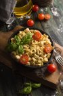 Homemade ravioli with basil and tomatoes — Stock Photo