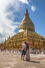 Young couple in love enjoying view of golden pagoda — Stock Photo