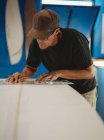 Craftsman making surf board in workshop — Stock Photo