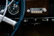 Fragment of metal steering wheel and dashboard of old classical automobile — Stock Photo