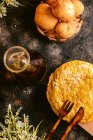 Top view of dish of eggs and potatoes near with pitcher of oil on table in kitchen — Stock Photo