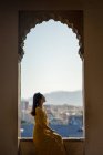 Female traveler in arch of old fortress — Stock Photo