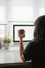 Anonymous woman taking photo on smartphone at workplace — Stock Photo