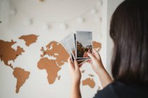Unrecognizable woman looking through photos at home — Stock Photo
