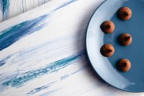 Plate with tasty chocolate truffles on table — Stock Photo