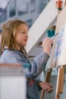 Happy child drawing on canvas — Stock Photo