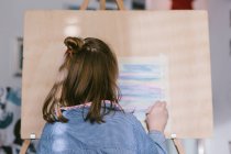 Child drawing on canvas — Stock Photo