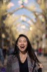 Happy young woman on street in downtown — Stock Photo