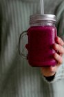 Person holding glass jug of delicious berry smoothie — Stock Photo