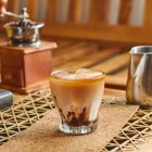 Tasty fragrant iced coffee with milk — Stock Photo