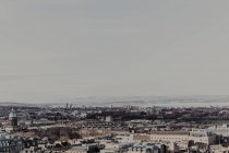 Desde arriba vista aérea del distrito histórico de la ciudad costera envejecida contra el mar y el cielo gris sin nubes - foto de stock