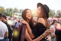 Charming long haired stylish friends having fun in bright day at festival — Stock Photo
