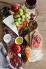 Top view of colorful fresh fruits meat vegetables and sauces for wine in hotel — Stock Photo