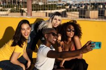 Jovens alegres diversas amigas tirando selfie no smartphone na rua — Fotografia de Stock