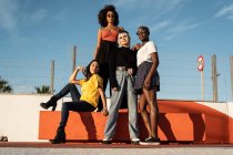 Giovani amici femminili multietnici fiduciosi che si divertono passatempo in strada — Foto stock