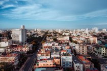 From above of colorful buildings and skyscraper with blue sky on background on streets of Cuba — Stock Photo