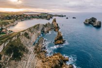 Amazing aerial landscape of steep rocky shore and breathtaking wavy ocean in cloudy day in Pielagos, Cantabria, Santander, Spain — Stock Photo