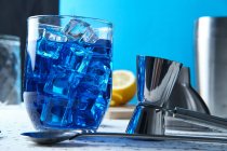 Delicious blue drink with ice in glass — Stock Photo