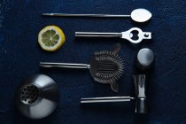 Stainless steel set of bartender tools on table — Stock Photo