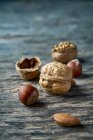 Зверху смачно свіжі зібрані лісові горіхи та напівчистий горіх на дерев'яному столі — стокове фото