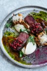 From above delicious rare steak with sweet cranberry sauce served with herbs and mushrooms with cheese on plate — Stock Photo