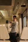 Jovem passageiro do sexo masculino usando smartphone no metrô — Fotografia de Stock