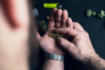 Homme méconnaissable faisant joint de cannabis à la maison — Photo de stock