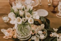 Elegant banquet with flowers under tent — Stock Photo
