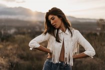 Sensual topless woman in jacket standing in countryside — Stock Photo