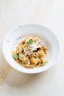 De cima de prato saboroso com massa larga polvilhada com queijo e decorada com hortelã fresca em restaurante — Fotografia de Stock