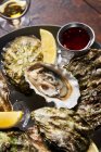 Fresh oysters with lemons in restaurant — Stock Photo