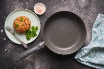 Tasty cutlets in pan and plate — Stock Photo