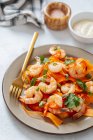 From above plate with yummy shrimp salad and fork placed on table during lunch at home — Stock Photo