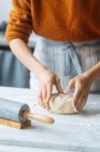 Cook kneading dough with hand on table — Stock Photo