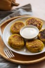 Delicious vegetable cutlets with sour cream on table — Stock Photo