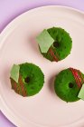 Donuts with green icing on plate — Stock Photo