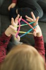 Smart children using rubber bands for game — Stock Photo