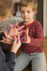 Smart children using rubber bands for game — Stock Photo