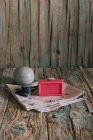 Plate with aromatic organic soap and flowers placed on napkin on shabby lumber table near cup with ingredient — Stock Photo